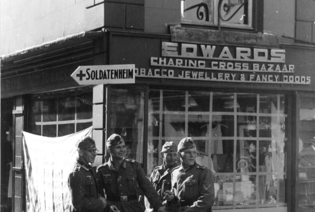 A group of German soldiers photographed outside a shop