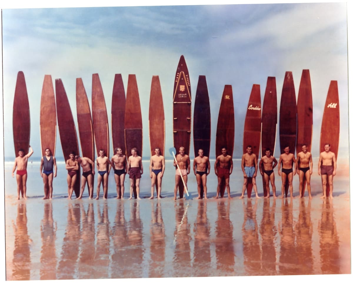 Group of male surfers with long boards