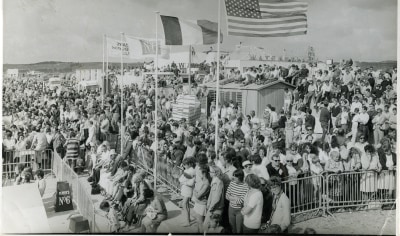 A large crowd watching a surf competition