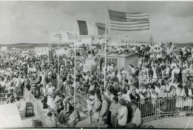 A large crowd watching a surf competition