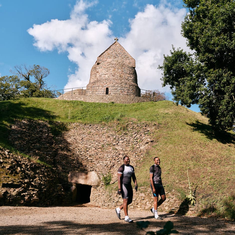 Two visitors walk at an ancient site