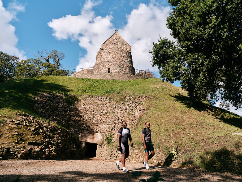 Two visitors walk at an ancient site