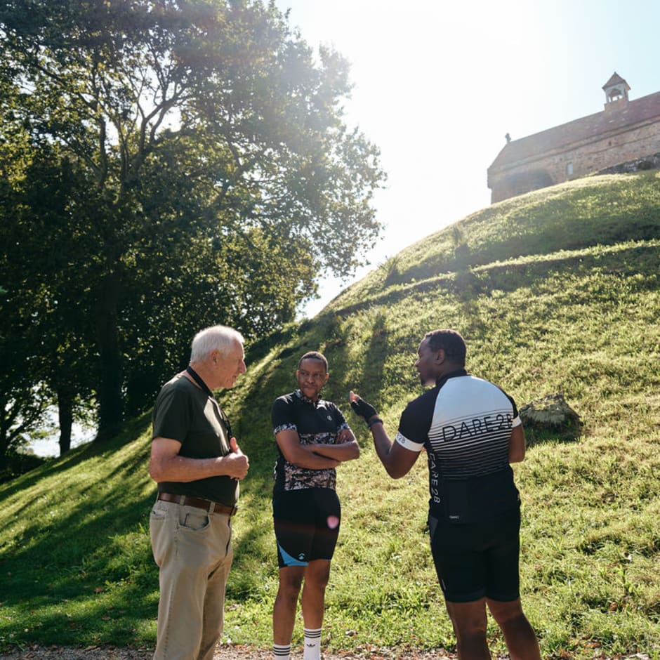 Two visitors talk to a guide