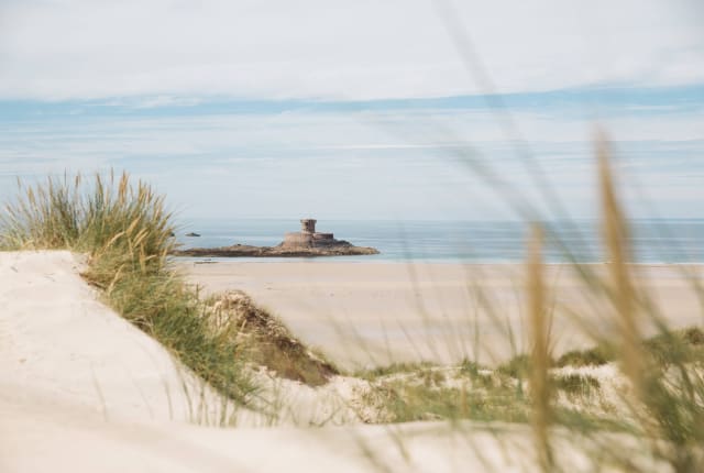 La rocco tower framed by sand dunes