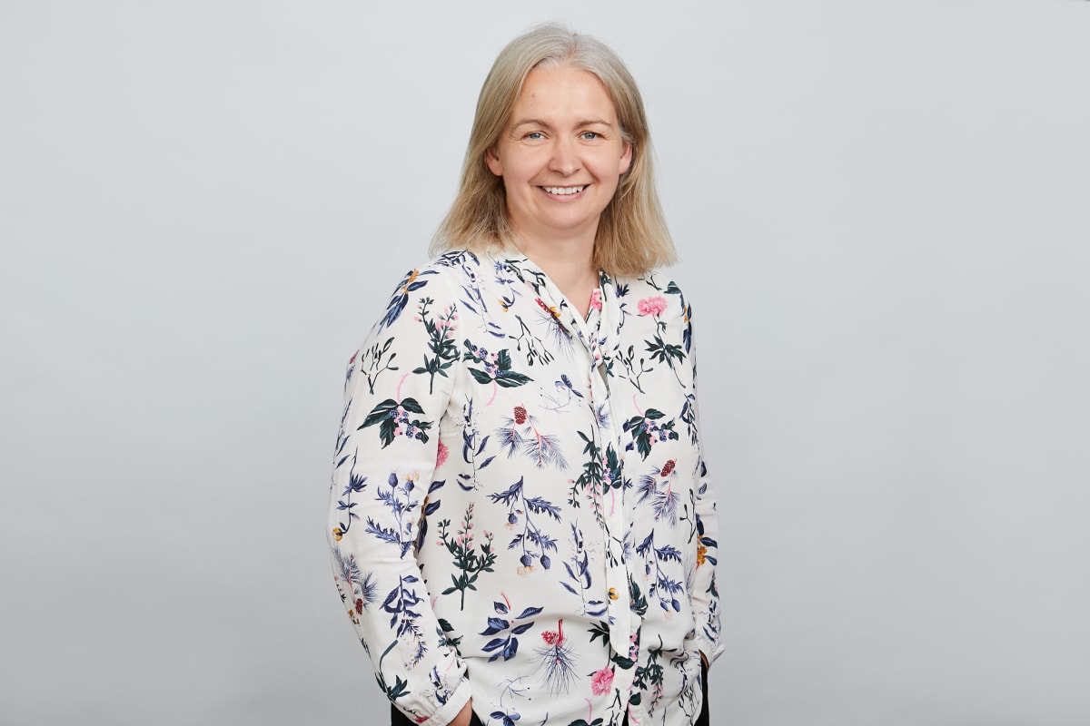 Woman in a printed white top.