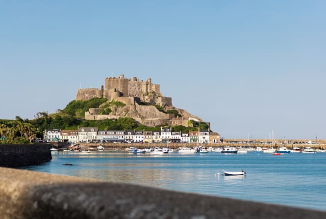A castle in the background within a harbour