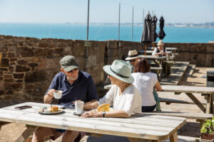 Couple enjoying refreshments at Mont Orgueil Castle