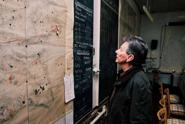 Cold War Bunker Man looks at large map on wall