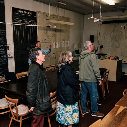 Cold War Bunker Visitors listen to talk in main room
