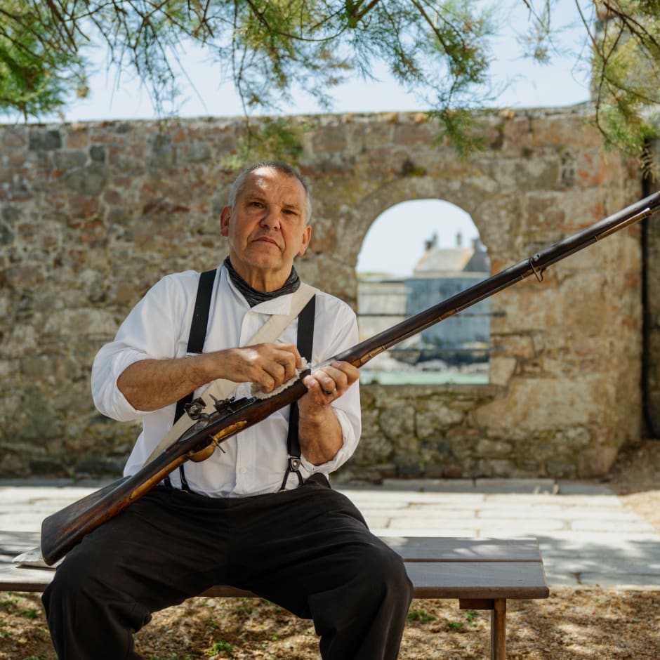 Man polishes old fashioned rifle