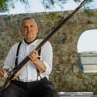 Man polishes fashioned rifle