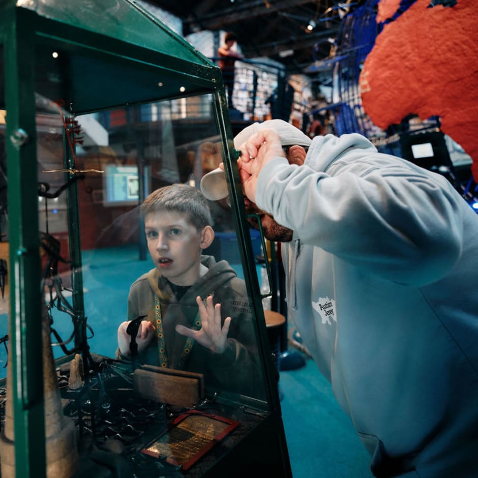 Boy and father play with exhibit