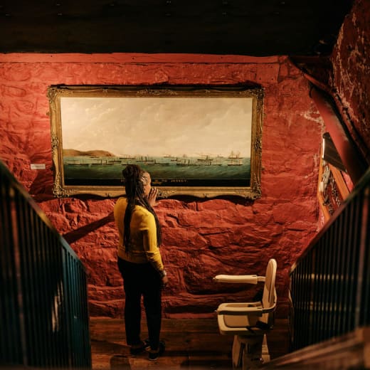 Women walks past painting