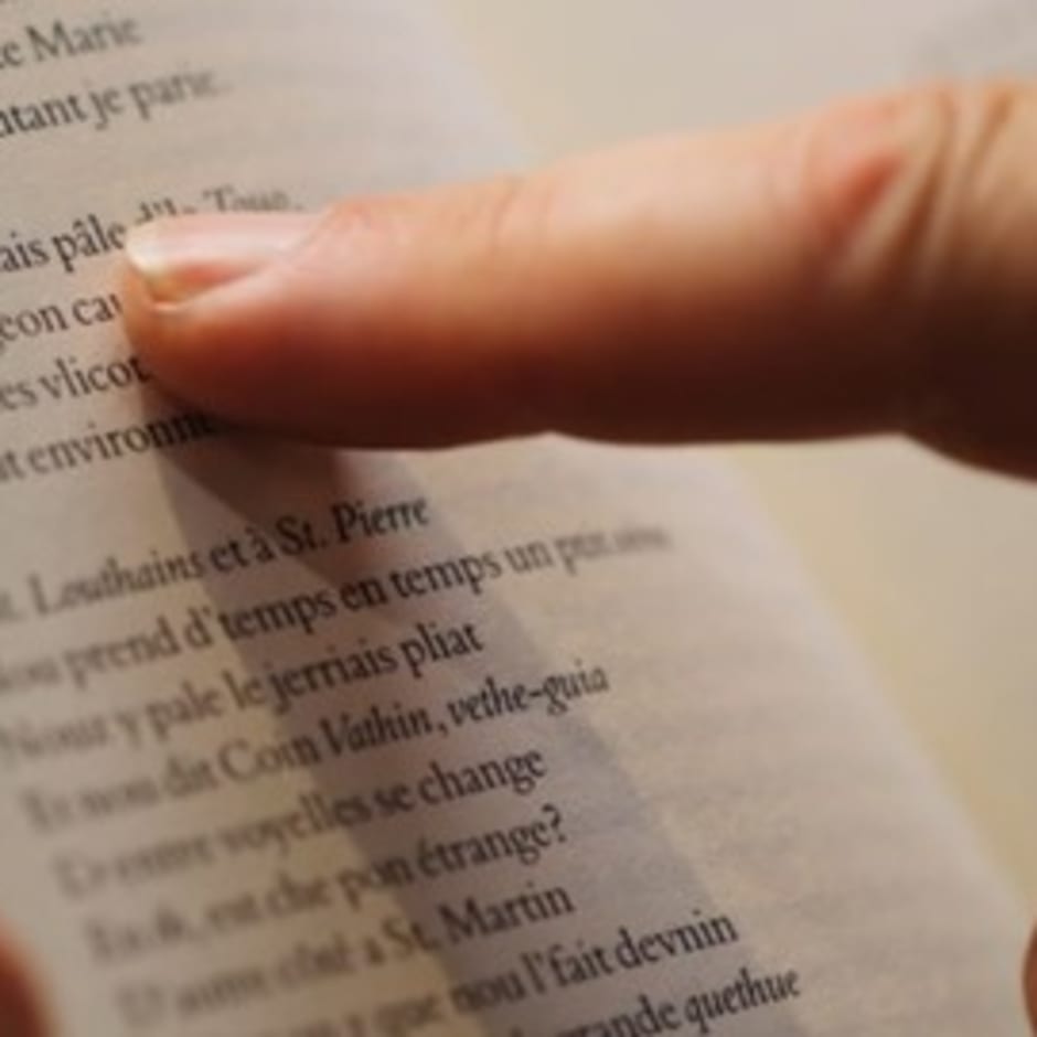 Finger pointing at a book