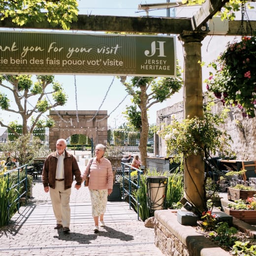 Jersey Museum couple walk through courtyard