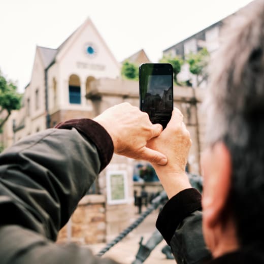 Jersey Museum man takes phone photo of front of museum