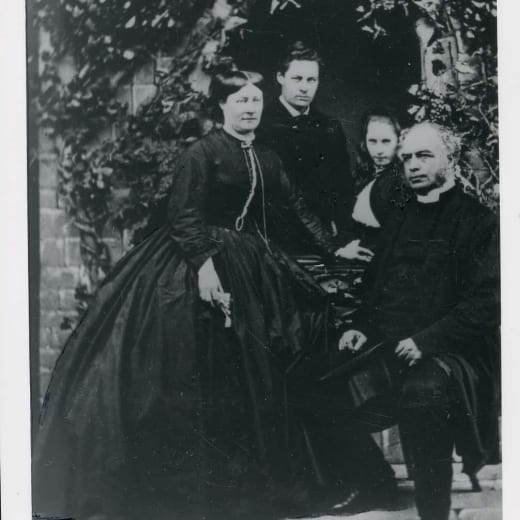 Black and white photograph of a women in Victorian dress with a young boy
