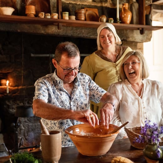 Couple make bread in old kitchen