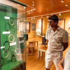 Man and women look at an exhibition case