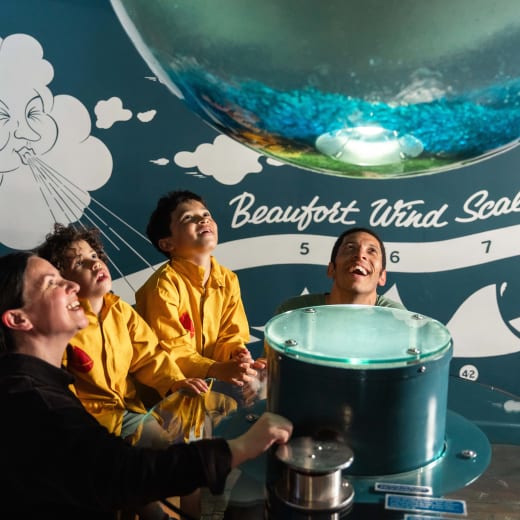 a family enjoy an interactive exhibit