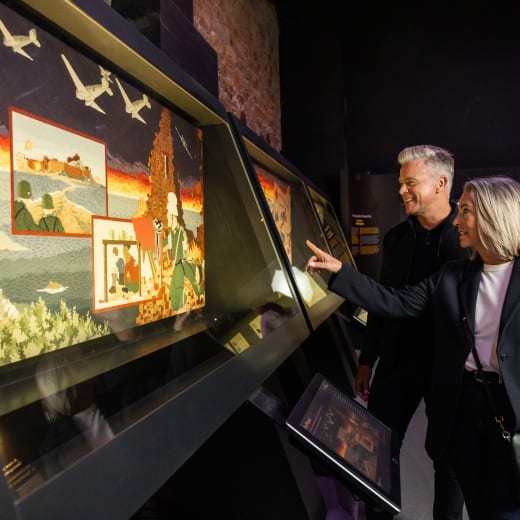 two people look at a bright exhibit