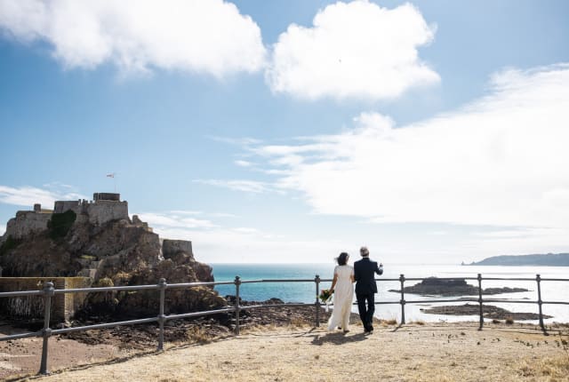 Man and Woman getting married walk towards Elizabeth Castle