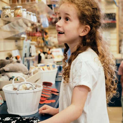 Maritime Museum young girl looks at shop items