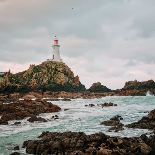 a lighthouse on a rocky outcrop