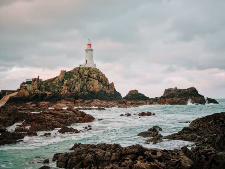a lighthouse on a rocky outcrop