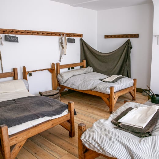 Beds made up in a bunk room