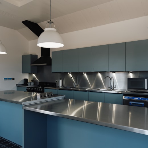 Blue kitchen with silver work tops