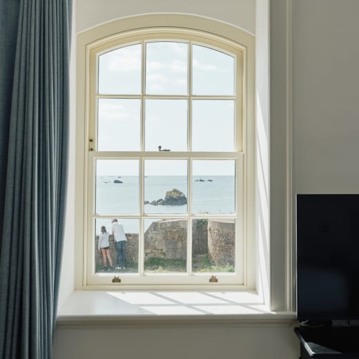 A window looks out to sea