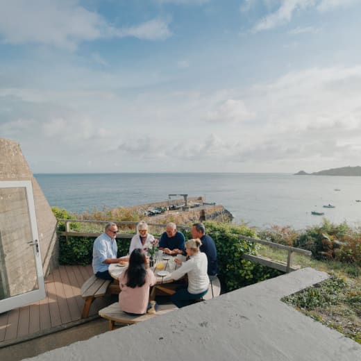 Group of people sit at a picnic bench