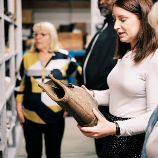 Sir Francis Cook Woman holds object from store with group