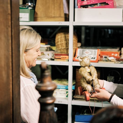 Sir Francis Cook women shows other women an items from the shelf