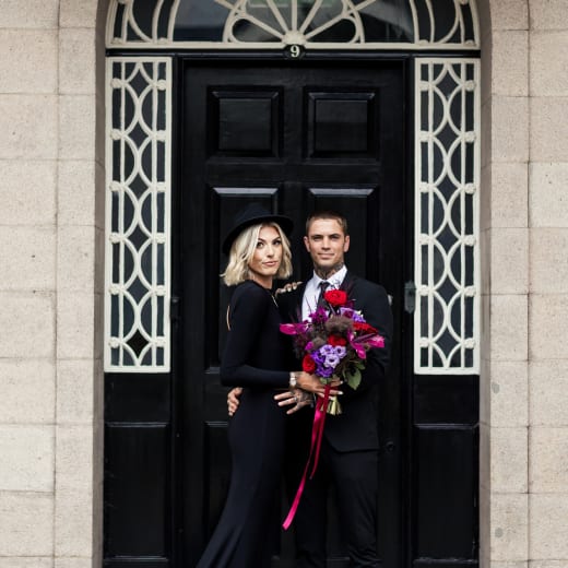 Victorian House Jersey Museum Bride and Groom pose by arched doorwary